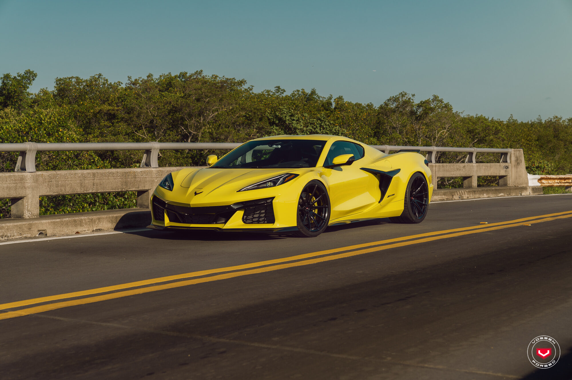 Accelerate Yellow Corvette C8 Z06 front three-quarter on a bridge