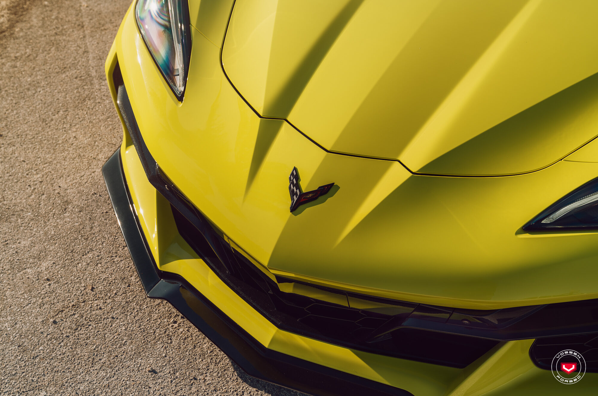 Corvette crossed-flags badge on the Accelerate Yellow hood